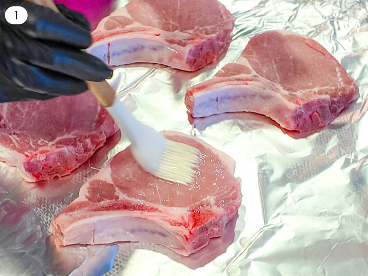 step 1 photo showing olive oil being brushed onto the pork chops