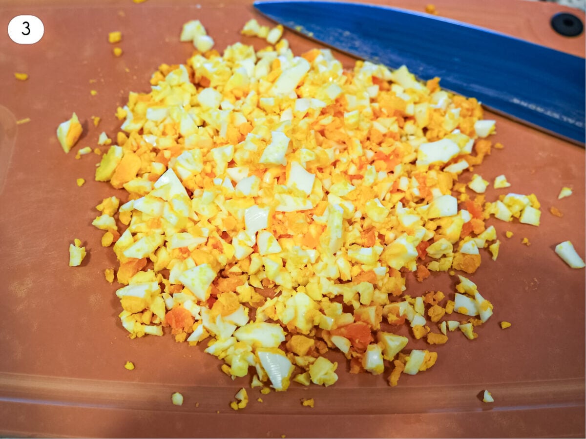 step 3 photo showing chopped up eggs on a cutting board