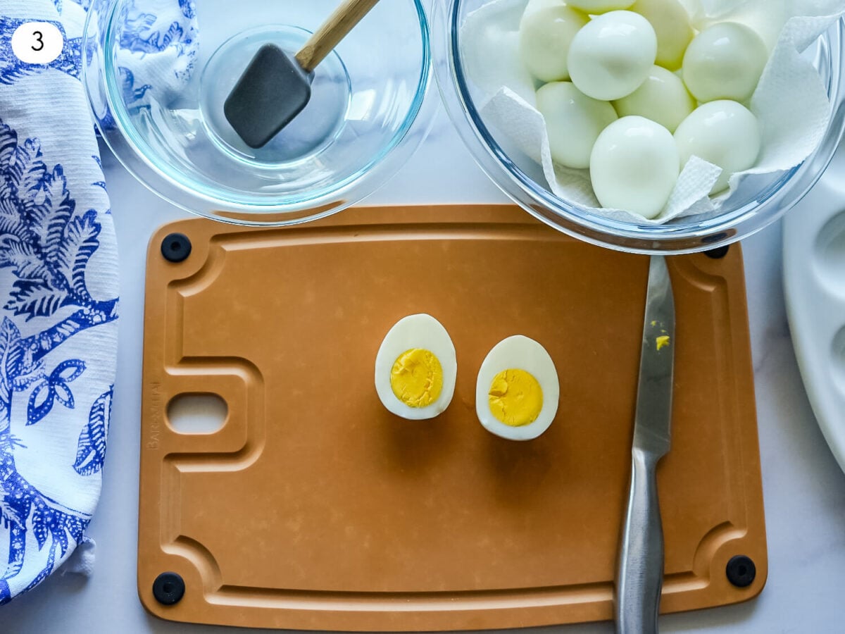 step 3 photo showing egg that is cut in half before yolks are removed