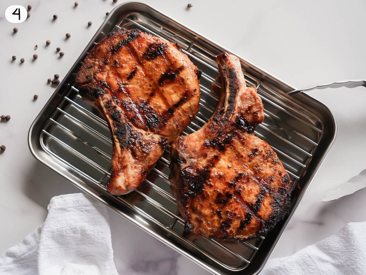 step 4 photo showing pork chops resting on a tray
