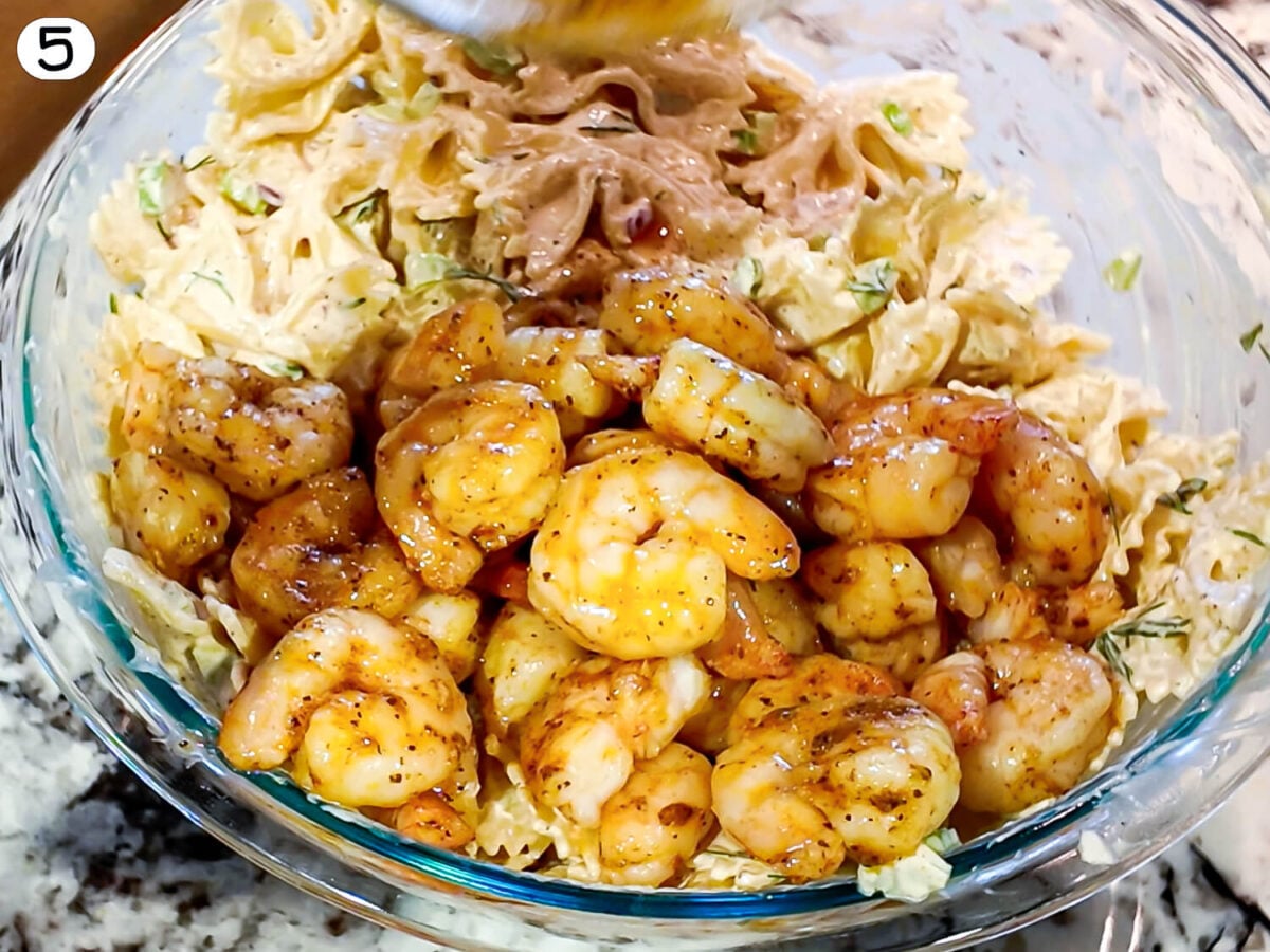 step 5 photo showing shrimp being mixed into the Seafood Pasta Salad