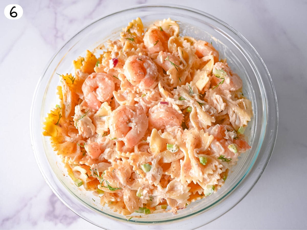step 6 photo showing combined Seafood Pasta Salad in a glass bowl