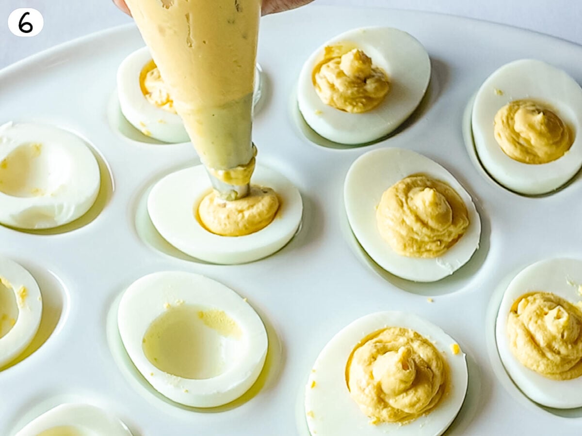 step 6 photo showing eggs being filled with Deviled Eggs mixture