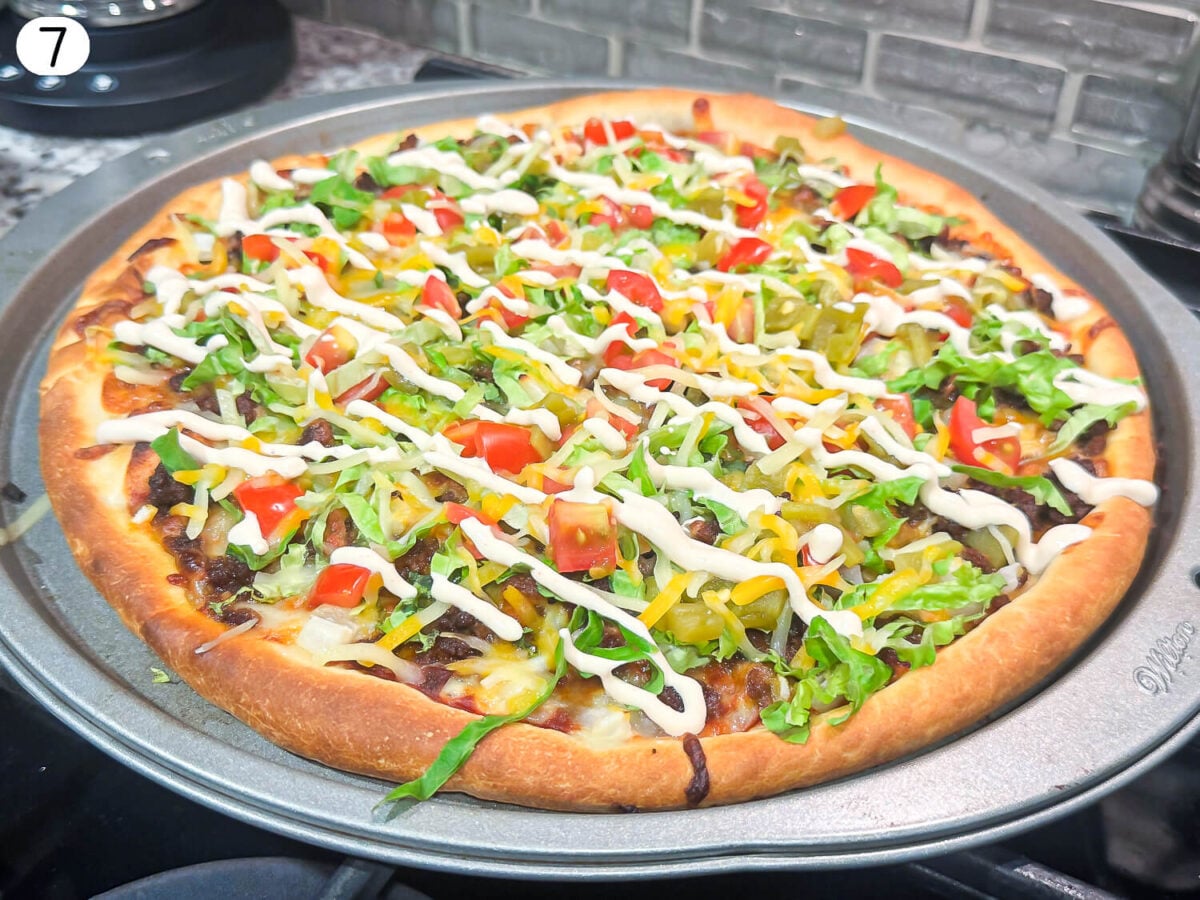 step 7 photo showing pizza with ingredients after it is baked
