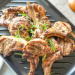 HERO overhead photo of grilled lamb chops on a grill plate