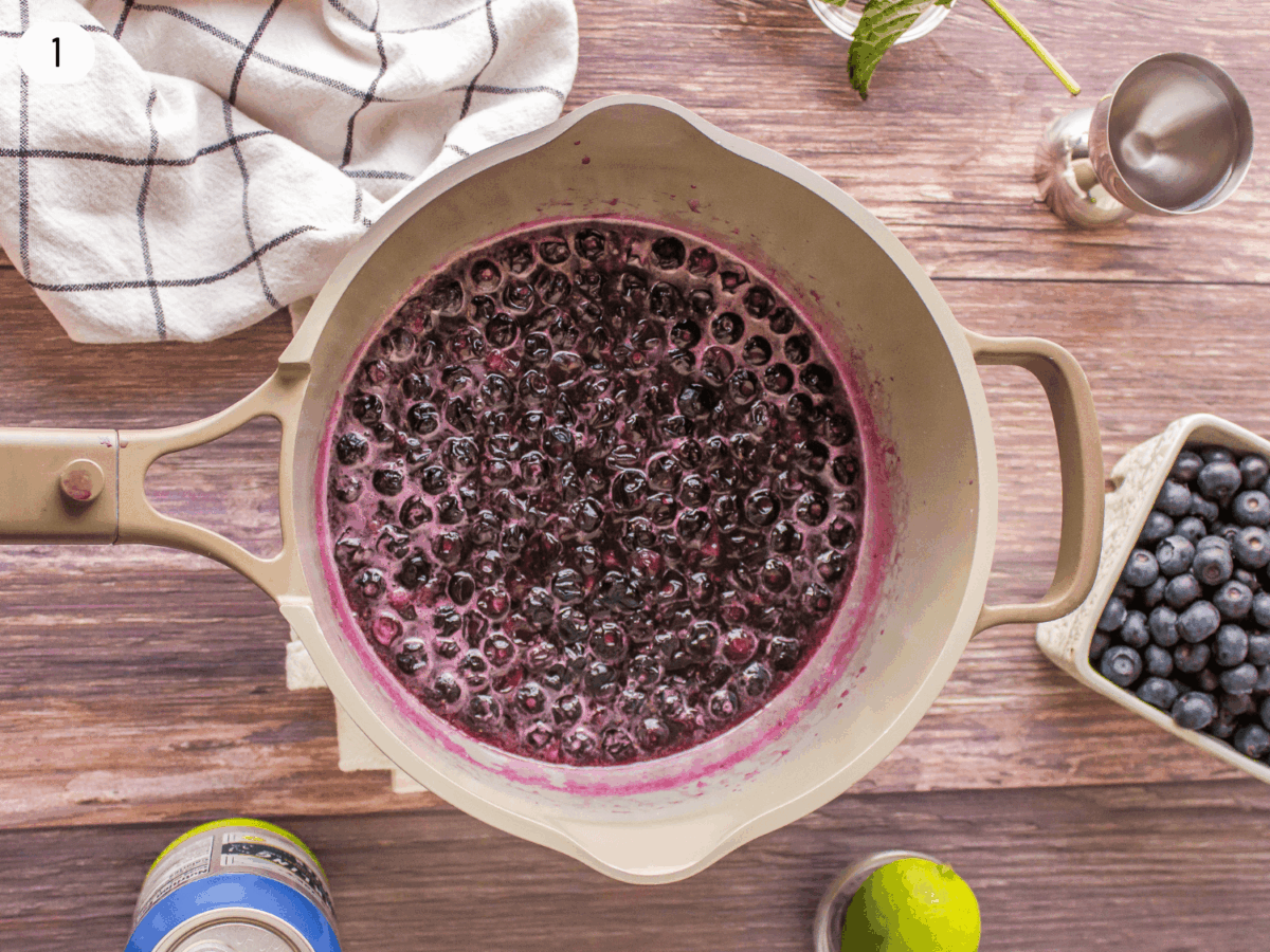 Step 1 photo of boiling blueberries in sugar and water to make blueberry syrup