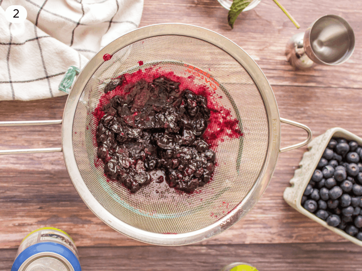 Step 2 photo showing blueberry syrup being strained