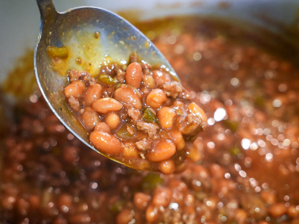 close up photo of beans being scooped out of the pot