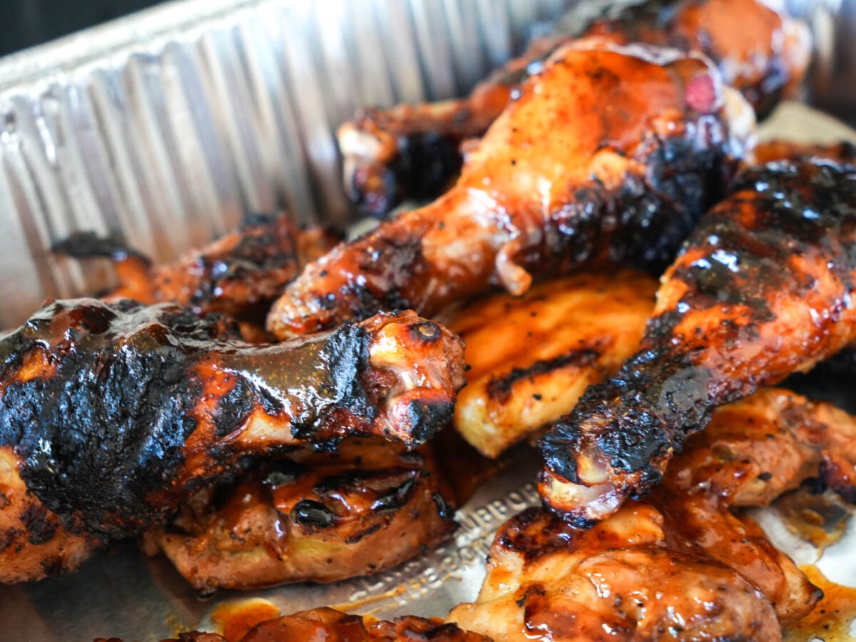 close up photo of honey bbq chicken in a metal pan