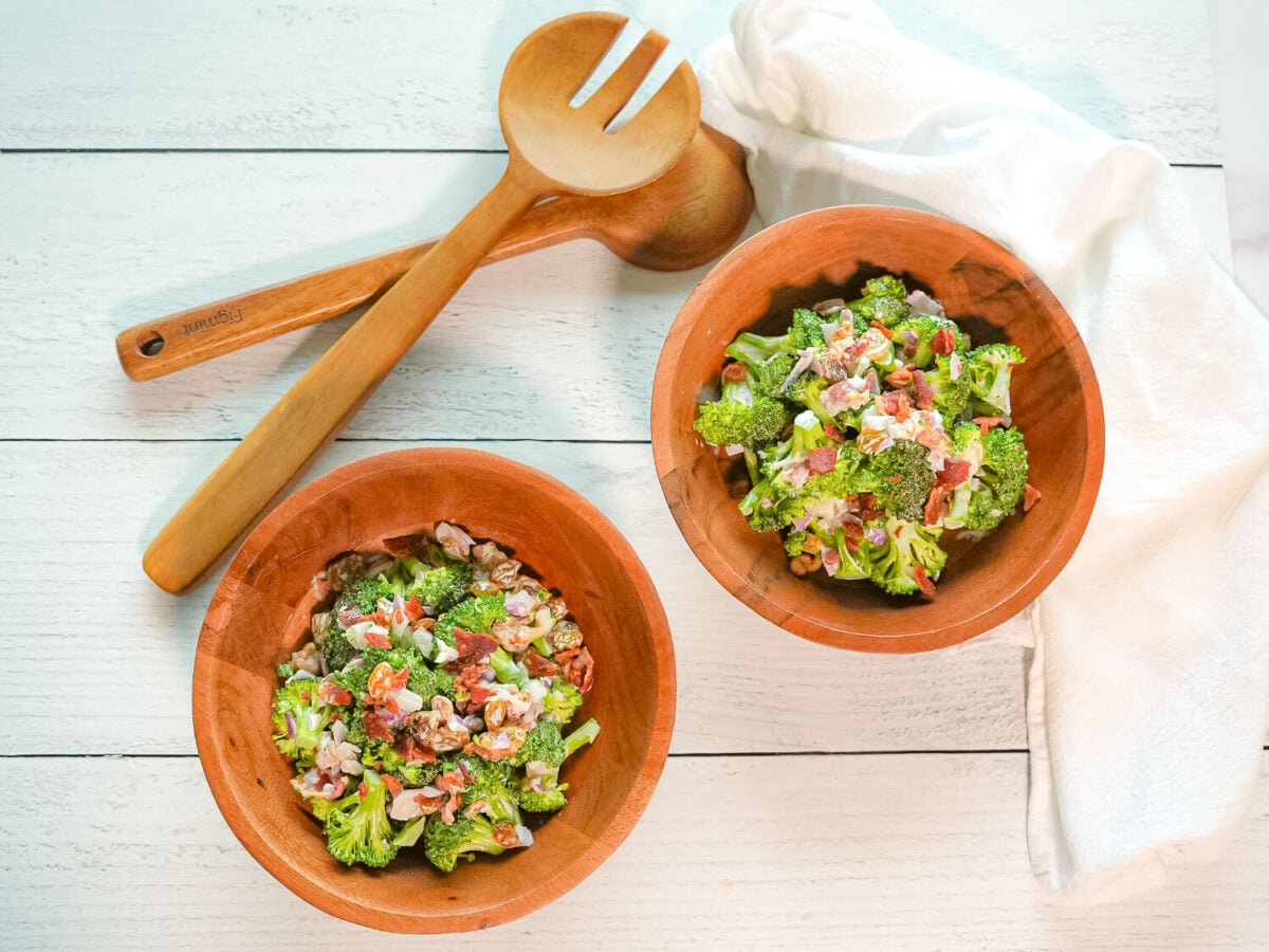 overhead photo of broccoli salad with bacon in two wooden bowls