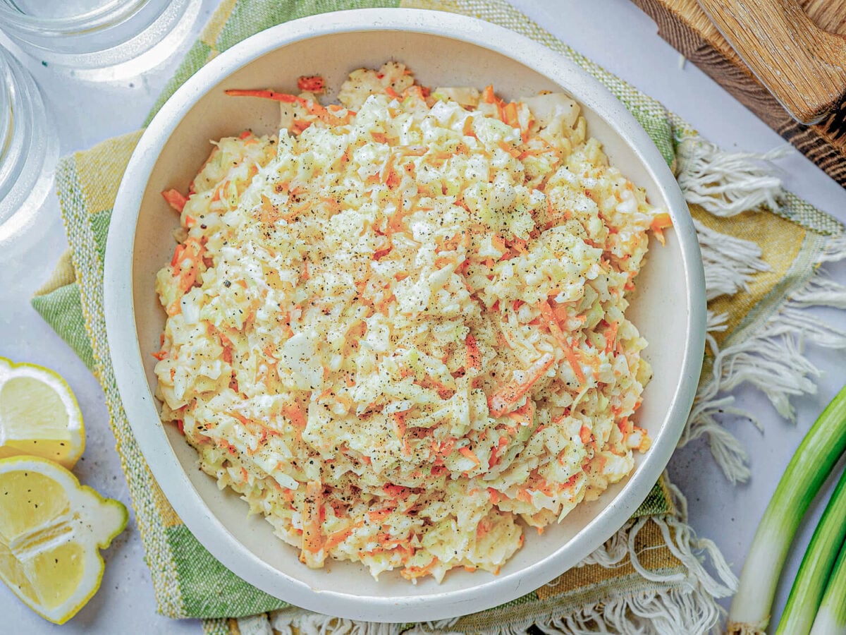 overhead photo of coleslaw in a white bowl