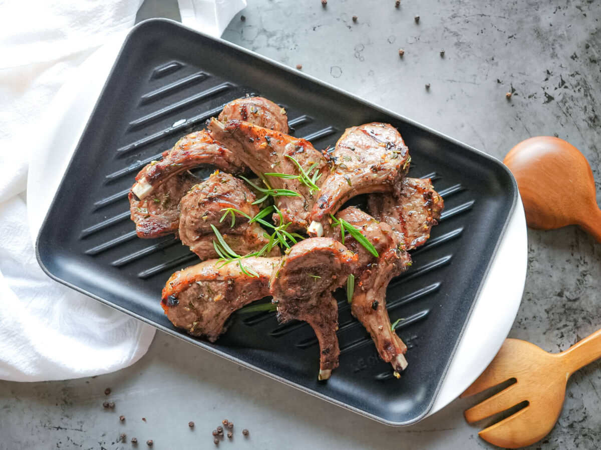 overhead photo of grilled lamb chops on a metal counter