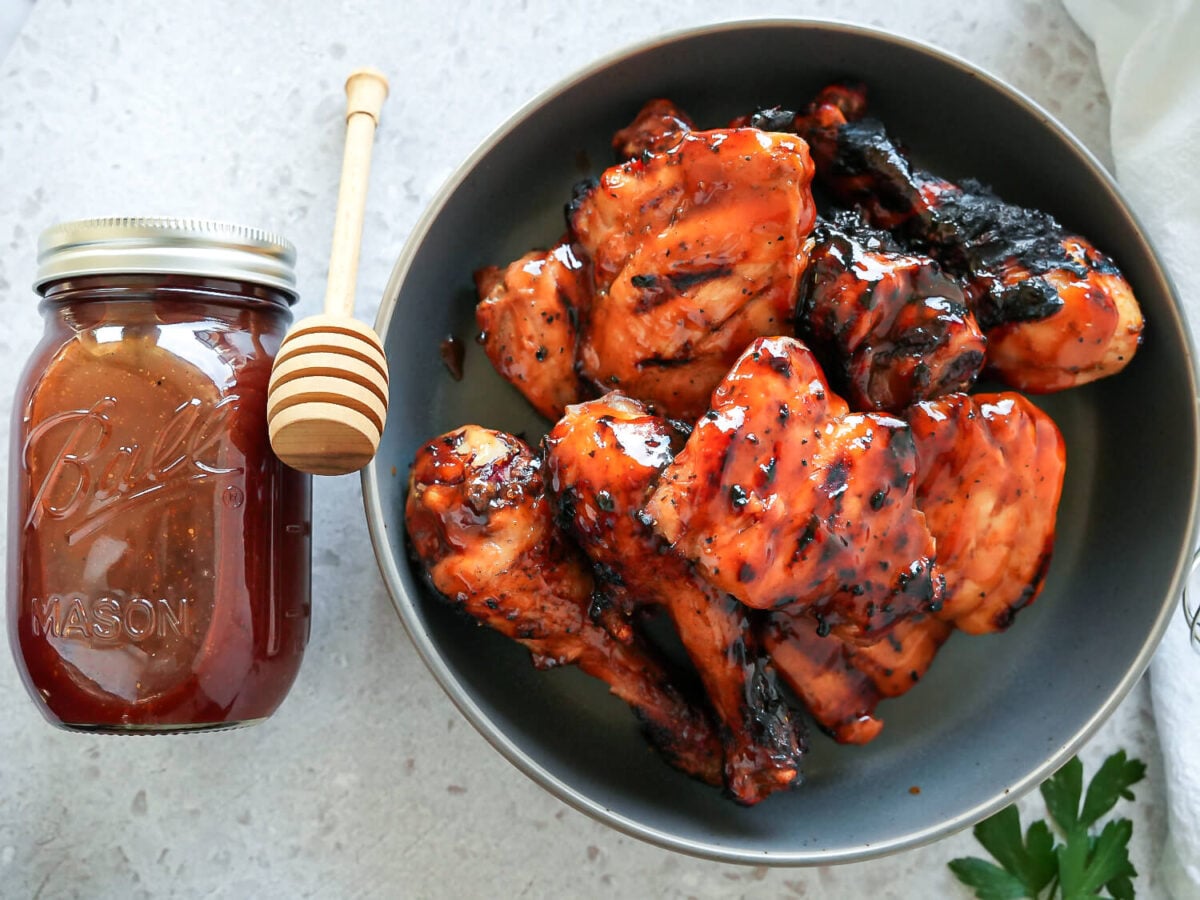 overhead photo of honey bbq chicken next to honey bbq sauce
