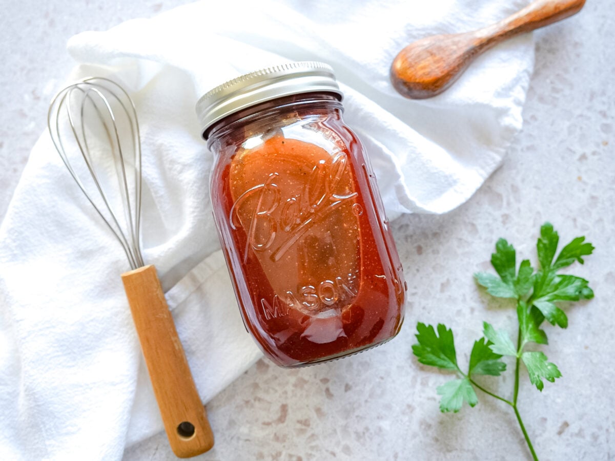 overhead photo of honey bbq sauce in a mason jar