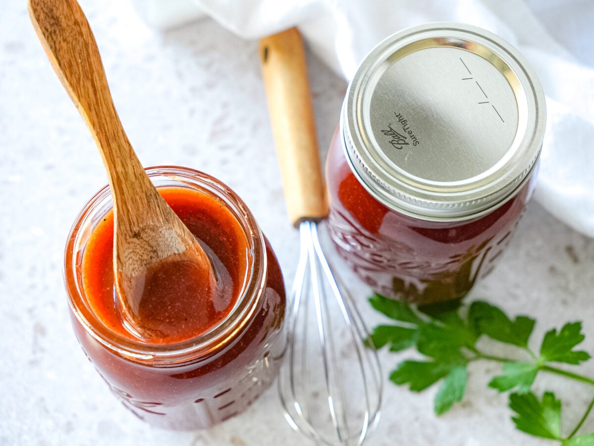 overhead photo of two mason jars of honey bbq sauces