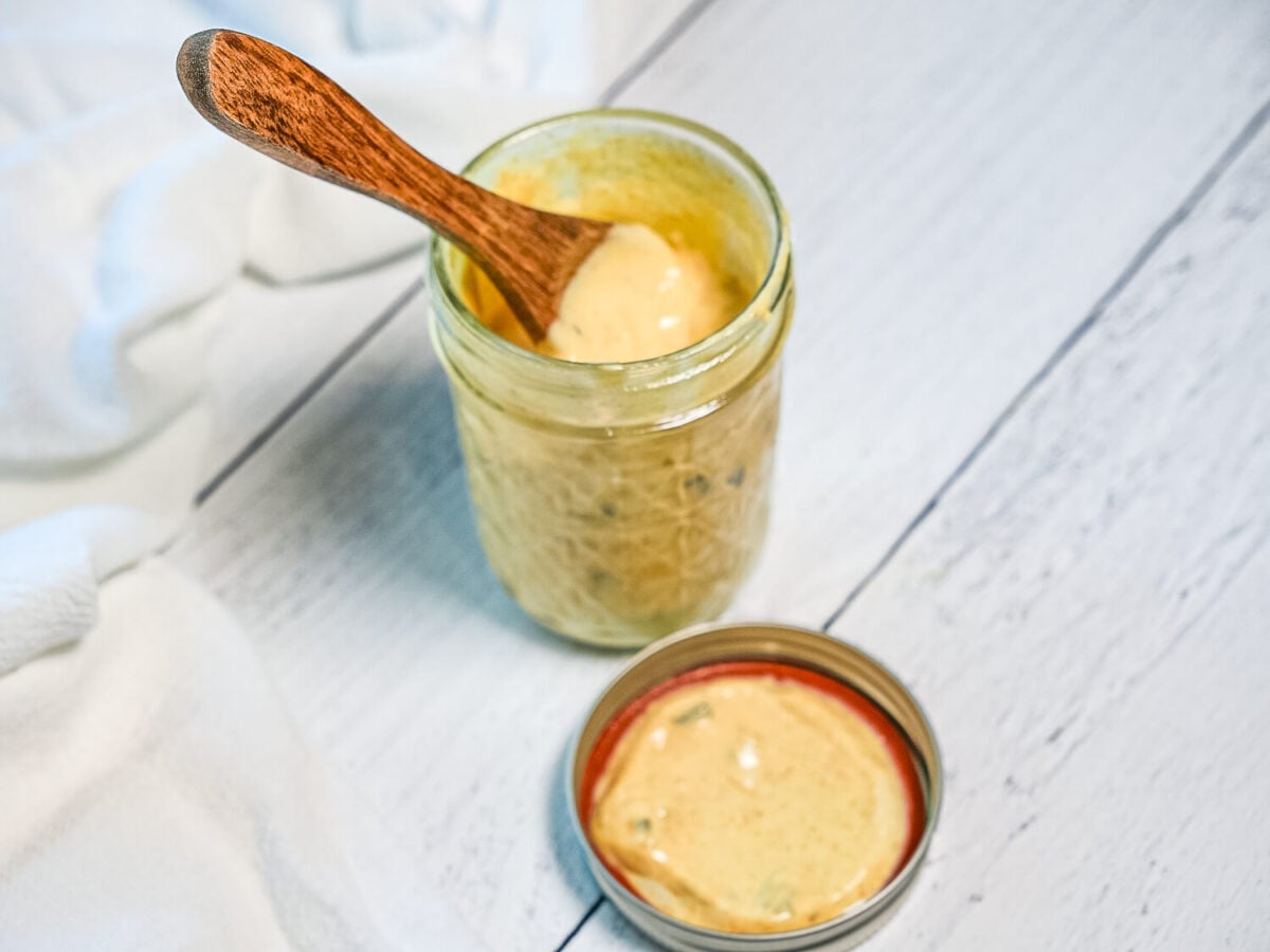 photo of Copycat Big Mac Sauce in a mason jar next to a lid