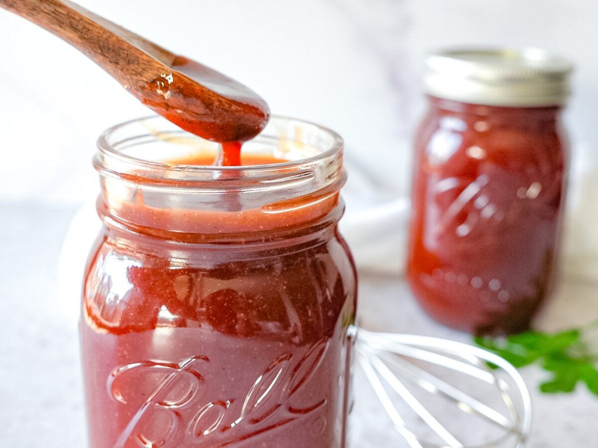 photo of honey bbq sauce dripping off of a wooden spoon