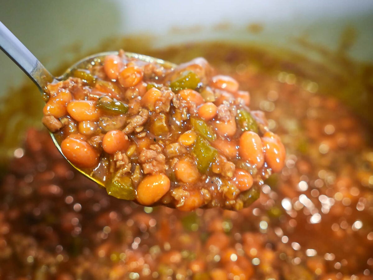 side photo of a spoon full of southern baked beans