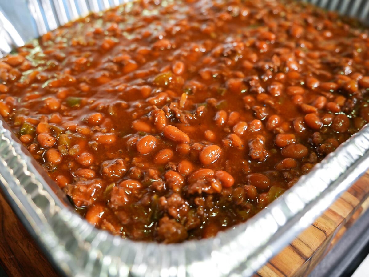 side view of baked beans in a a silver pan