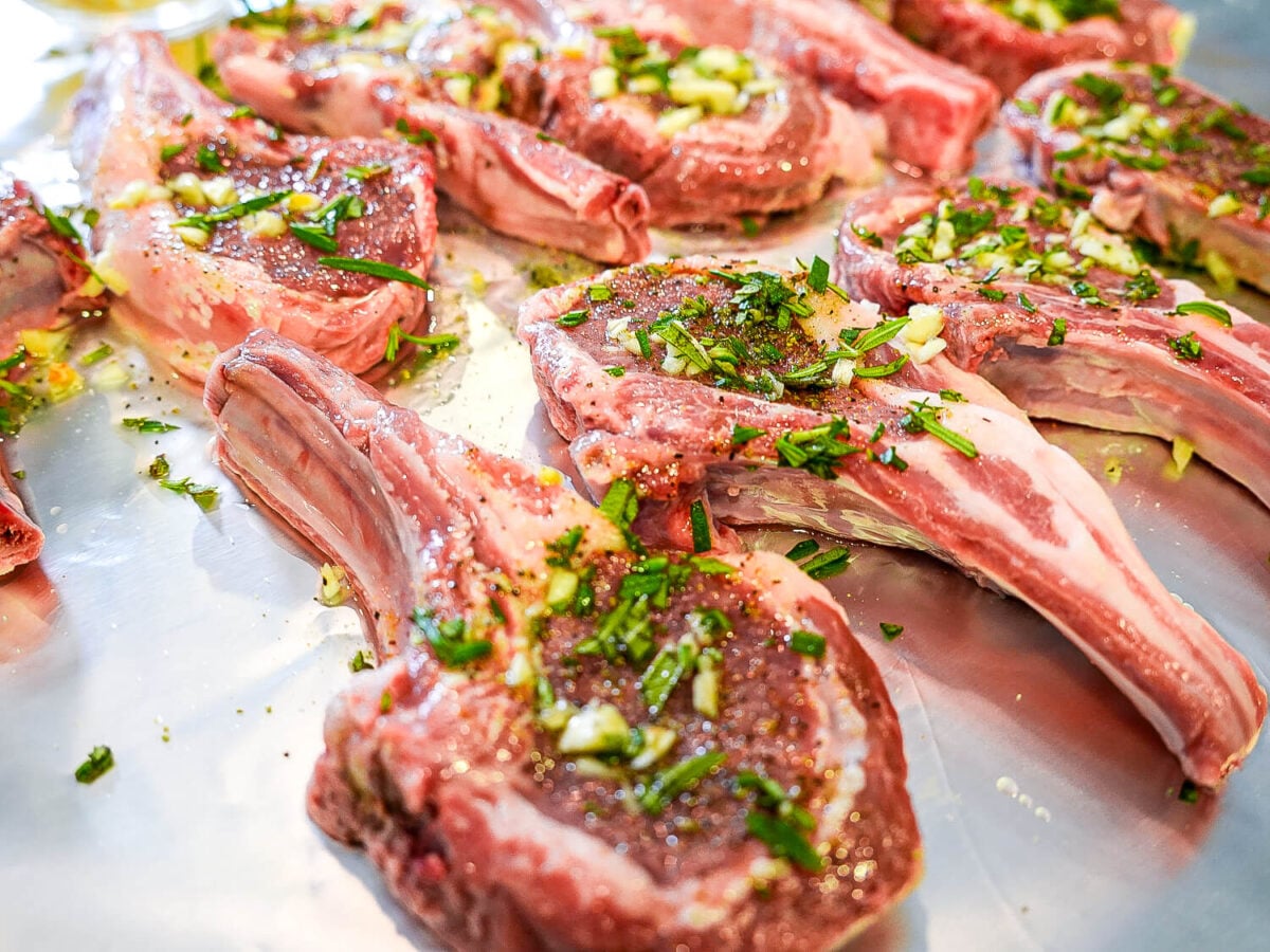 side view of lamb chops of rosemary and garlic on them