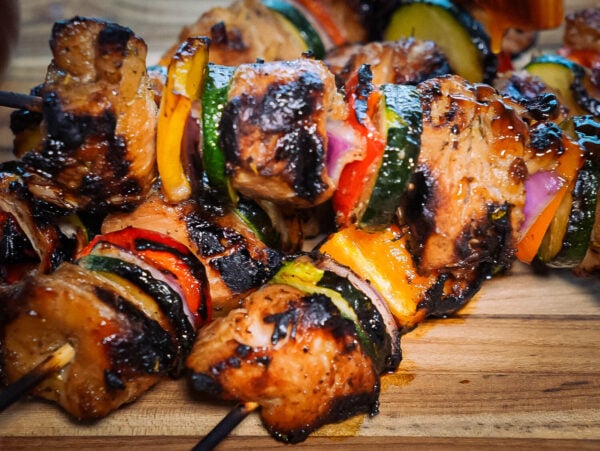 HERO Grilled chicken kabobs on a wooden cutting board