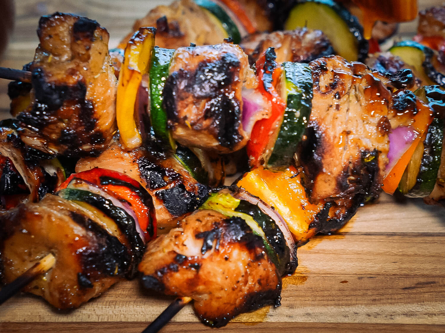 HERO Grilled chicken kabobs on a wooden cutting board
