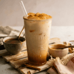 HERO of Iced Pumpkin Cream Chai with syrup in the background