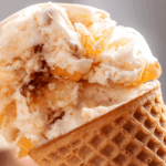close up photo of peach cobbler Ice Cream on a cone