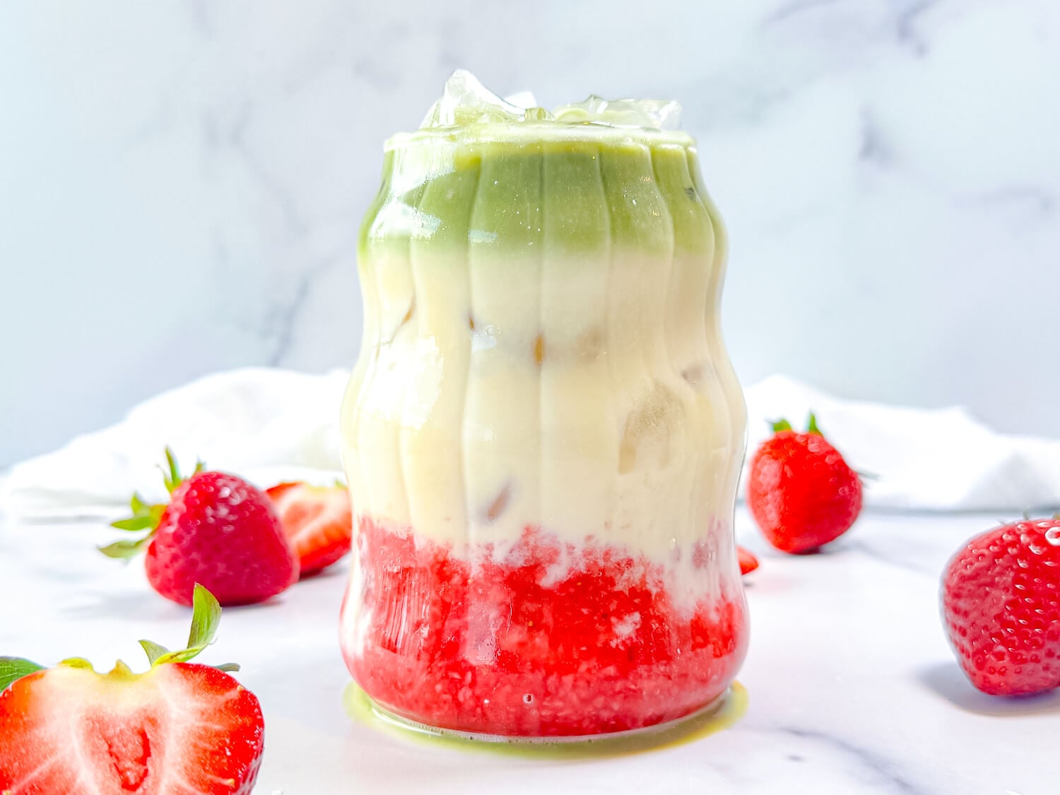 HERO photo showing a strawberry matcha on a marble surface