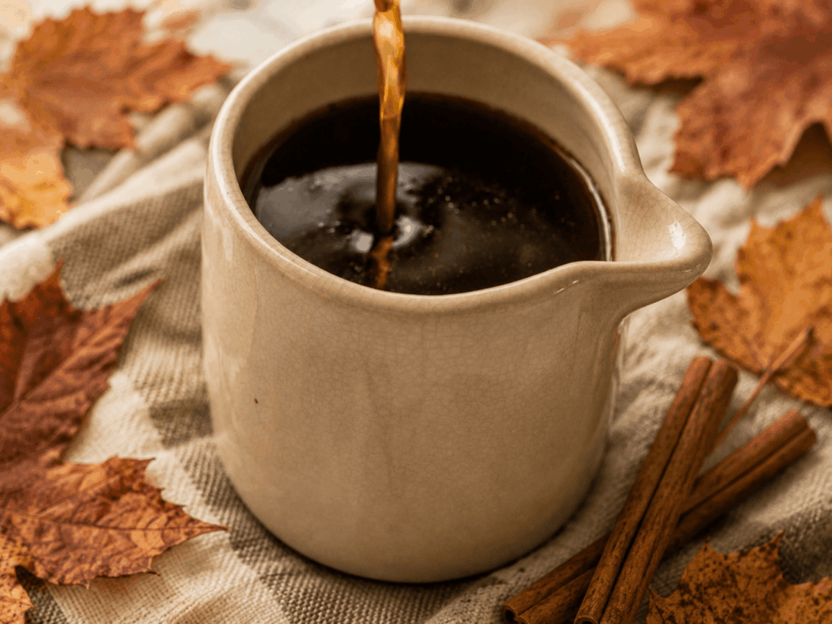 HERO side photo of Pumpkin Spice Syrup with leaves