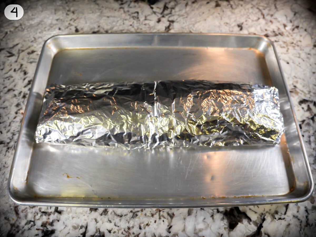 STEP 4 photo showing the ribs being wrapped up so they can marinate