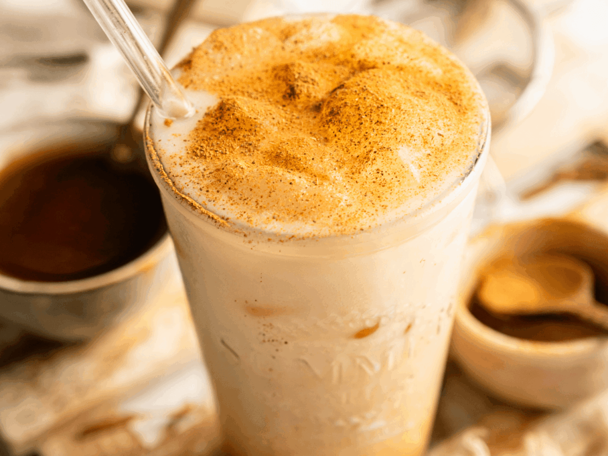 close up overhead photo of a Iced Pumpkin Cream Chai in a glass cup