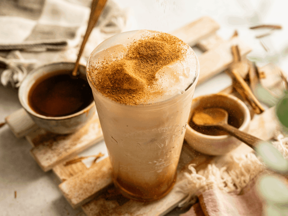 HERO of Iced Pumpkin Cream Chai with syrup in the background