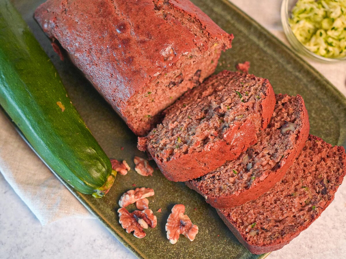 overhead photo showing 3 slices of Zucchini Bread next to a loaf