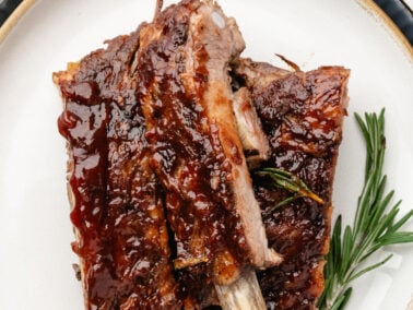 photo of bbq baby back ribs on a white plate