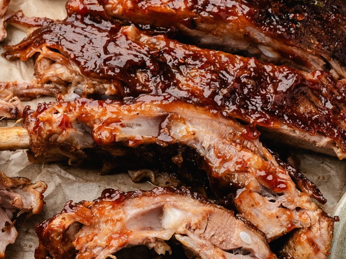 photo showing sauced bbq ribs on parchment paper