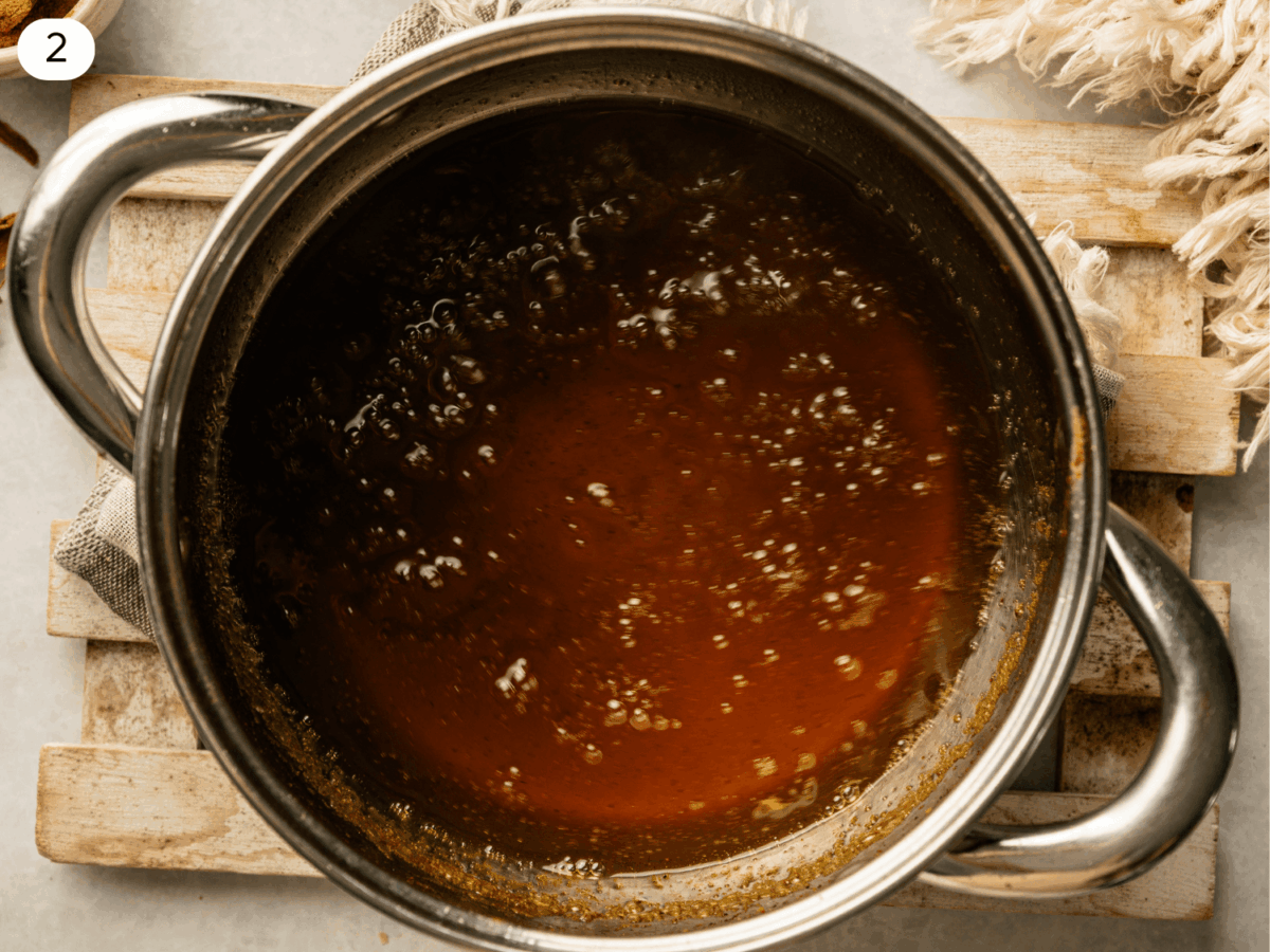 step 2 photo showing Pumpkin Spice Syrup ingredients dissolved in a sauce pan