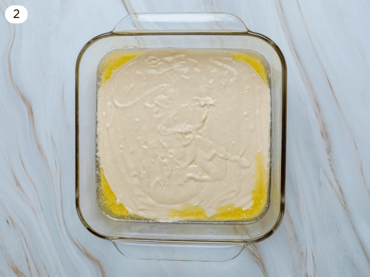 step 2 photo showing adding the cobbler mixture with the melted butter
