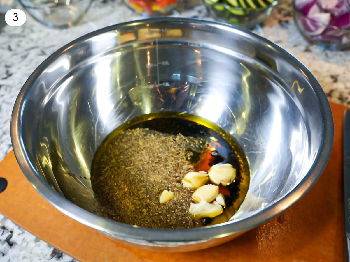 step 3 photo showing marinade ingredients in a silver bowl