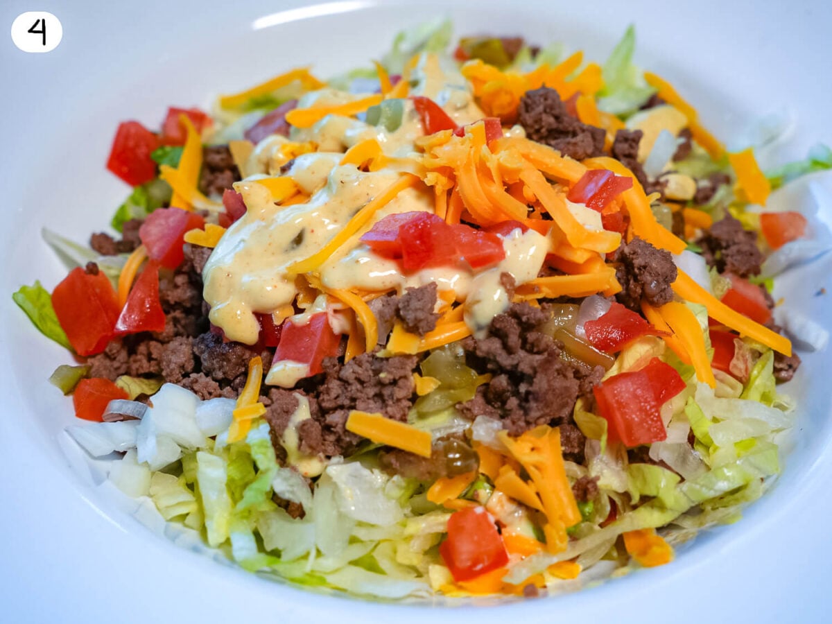 step 4 photo of salad being put together with big mac dressing