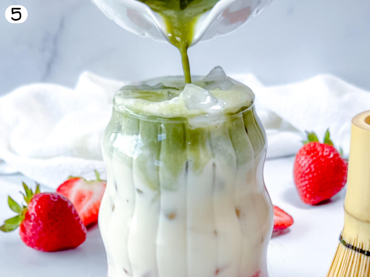 step 5 photo showing matcha being poured on top of oatmilk in a glass