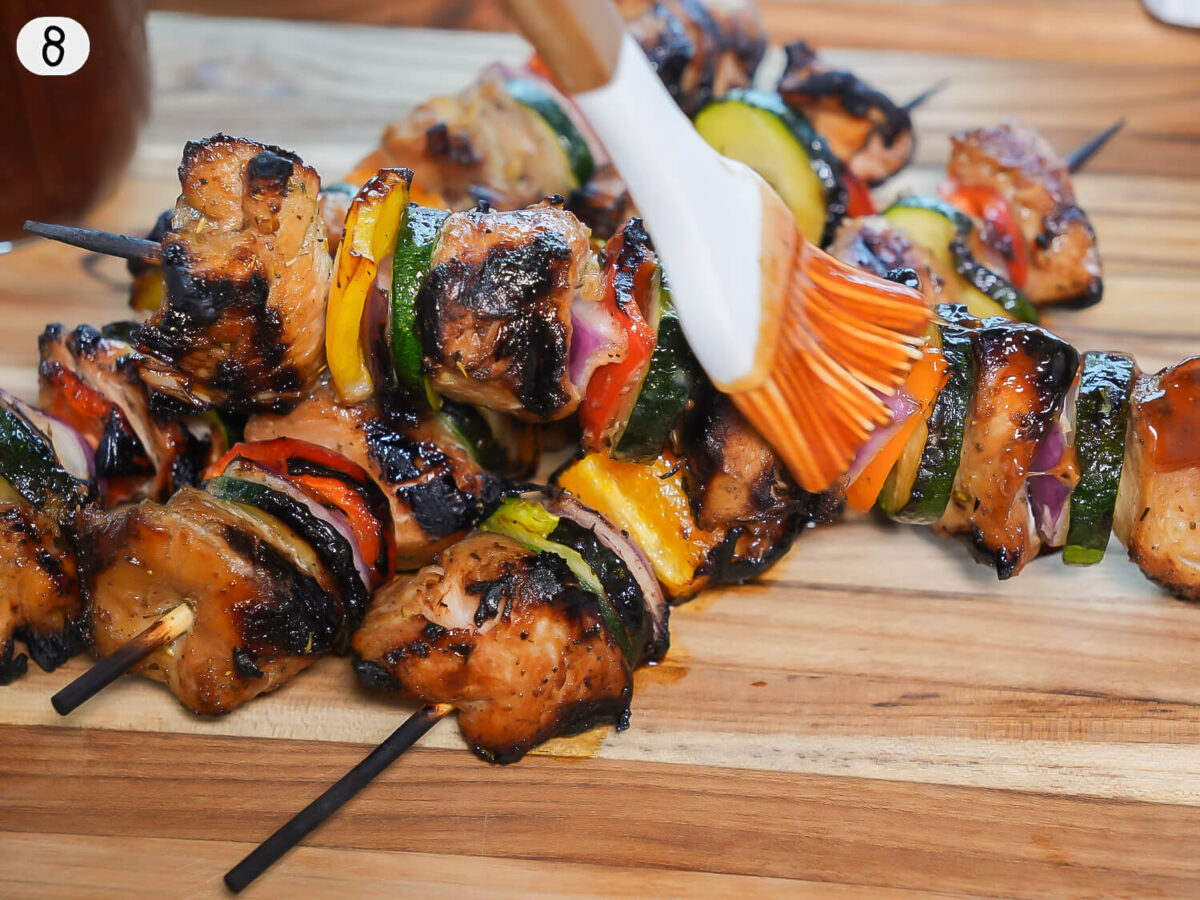 step 8 showing grilled chicken kabobs being brushed with bbq sauce 2