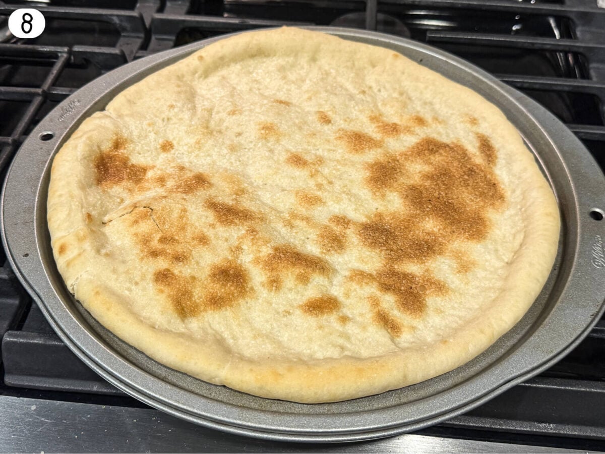 step 8 showing pizza dough after its prebaked
