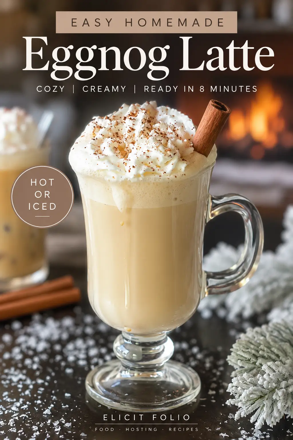 Vertical Pinterest graphic featuring a creamy eggnog latte topped with whipped cream, freshly grated nutmeg, and a cinnamon stick in a clear glass mug. Text reads “Easy Homemade Eggnog Latte,” “Cozy, Creamy, Ready in 8 Minutes,” and “Hot or Iced,” with a warm fireplace in the background.