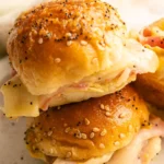 HERO zoomed in photo of a Hawaiian Bread Ham and Cheese Slider that's stacked on top of another one