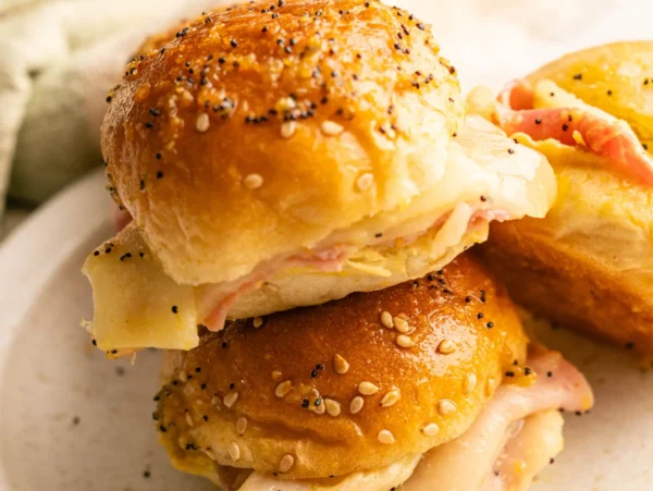 HERO zoomed in photo of a Hawaiian Bread Ham and Cheese Slider that's stacked on top of another one