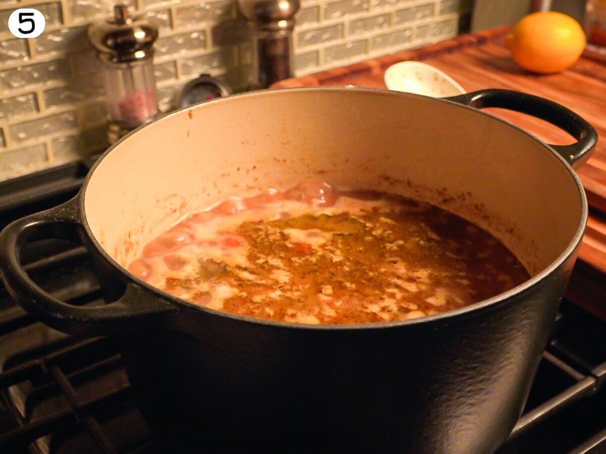 Step 5 photo showing the chicken and wild rice soup coming to a gentle boil