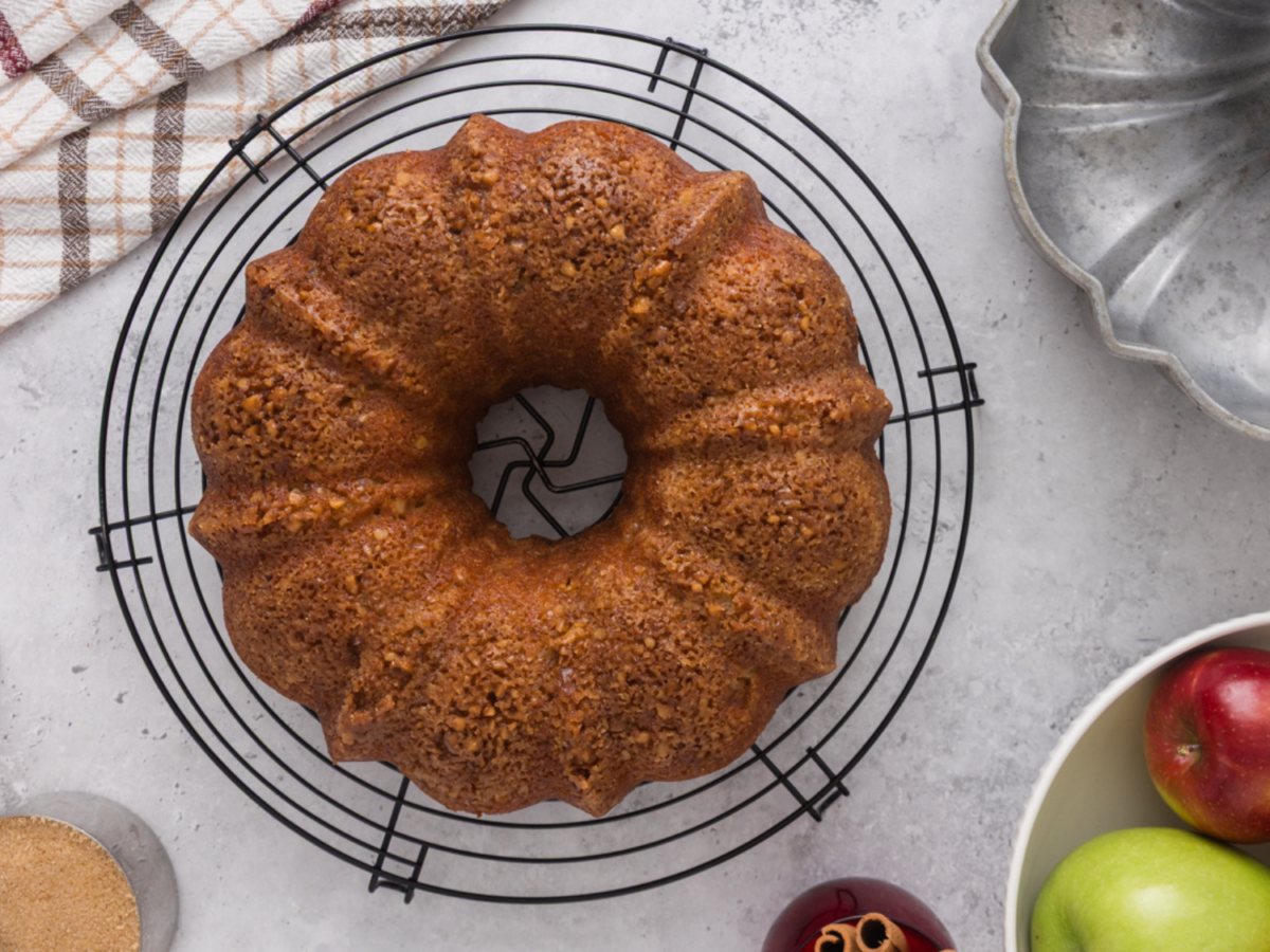 overhead photo showing an apple bundt cake on a cooling rack