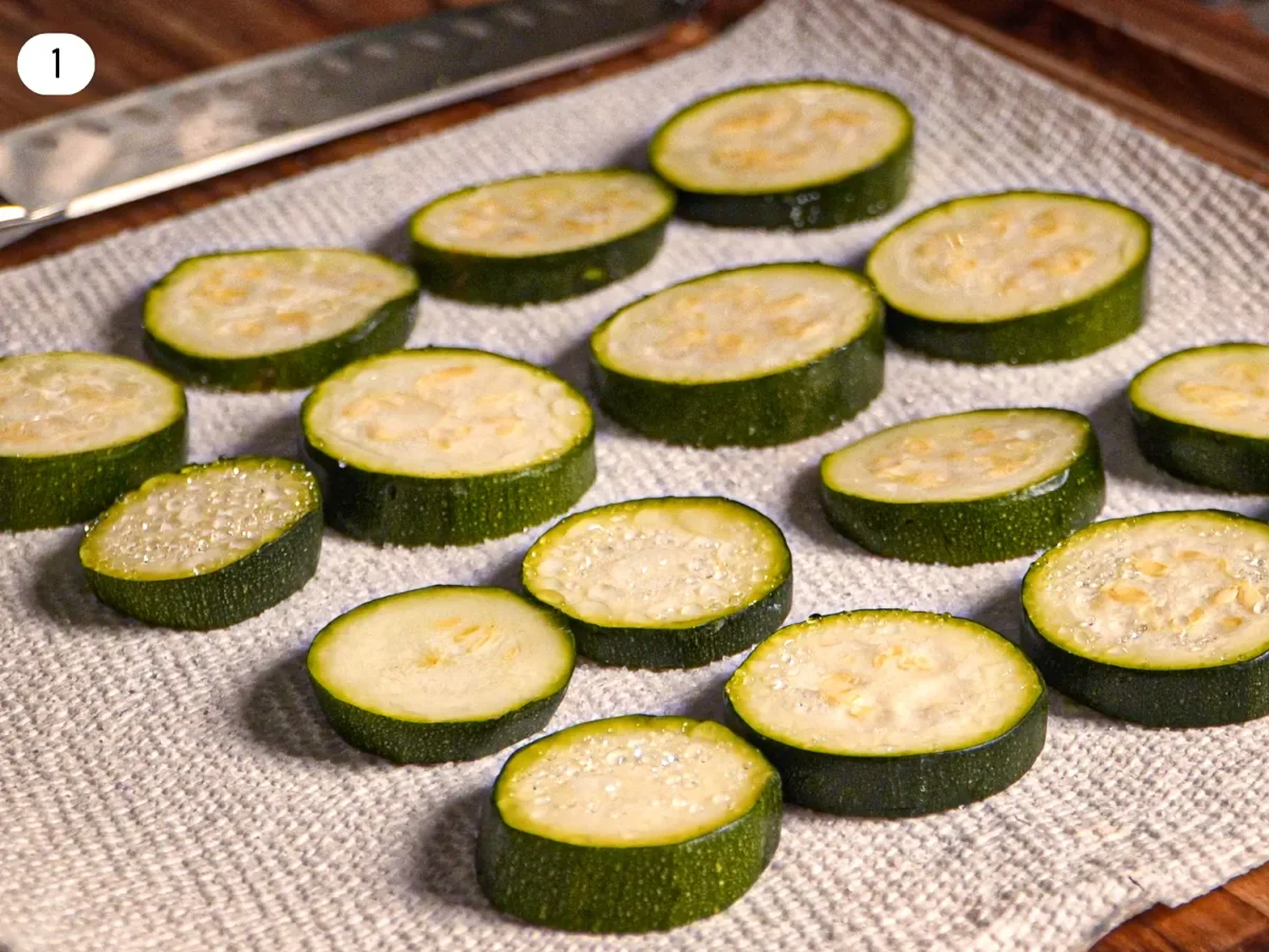 step 1 photo that shows water drops coming out of zucchini that was previously salted