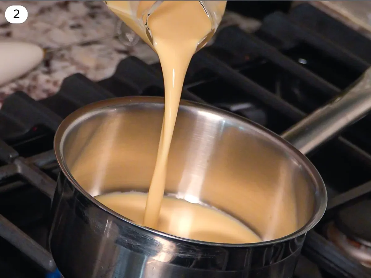 step 2 photo showing eggnog being poured into a saucepan